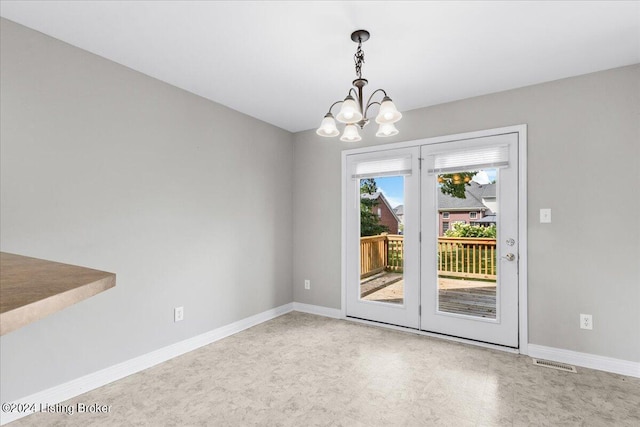 interior space featuring a notable chandelier, visible vents, and baseboards