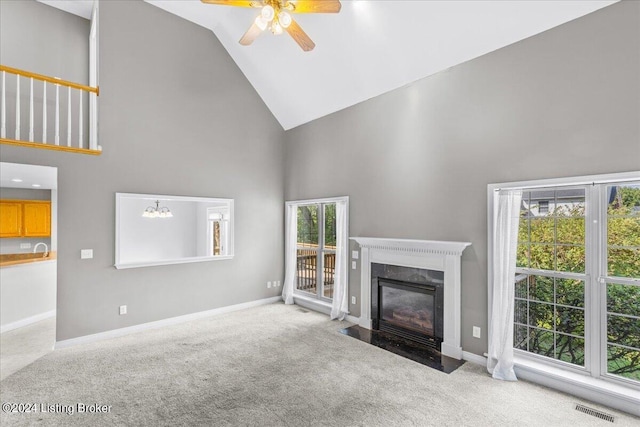 living room with visible vents, a premium fireplace, light carpet, high vaulted ceiling, and baseboards