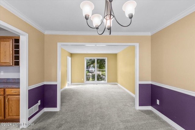 spare room featuring baseboards, crown molding, carpet flooring, and an inviting chandelier