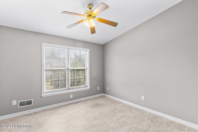 unfurnished room with visible vents, ceiling fan, light wood finished floors, and baseboards