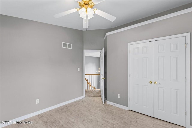 unfurnished bedroom with a closet, baseboards, visible vents, and light wood finished floors