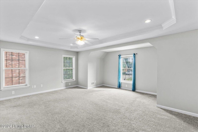 empty room featuring recessed lighting, light carpet, a ceiling fan, baseboards, and a raised ceiling