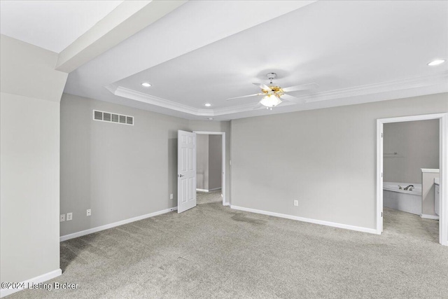 unfurnished bedroom featuring baseboards, visible vents, light colored carpet, a tray ceiling, and recessed lighting