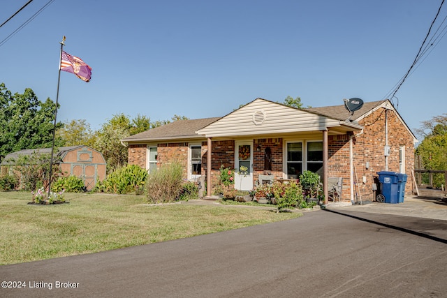 view of front facade with a shed and a front yard