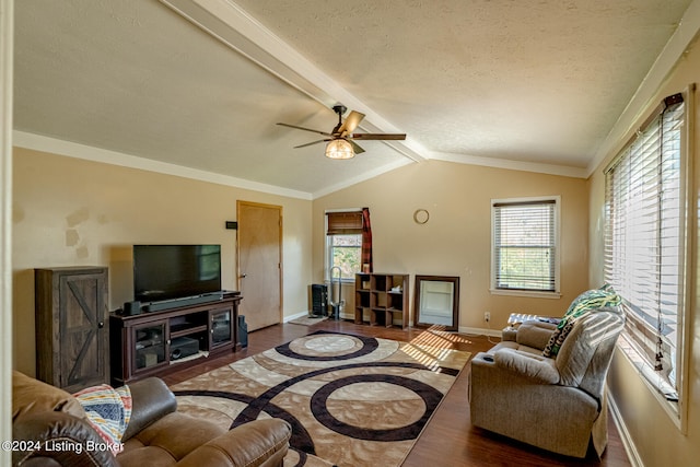 living room with ceiling fan, hardwood / wood-style flooring, lofted ceiling with beams, and a wealth of natural light