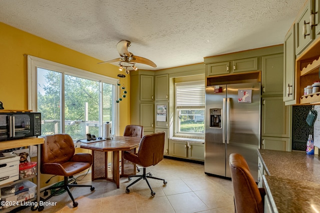 interior space with ceiling fan, a healthy amount of sunlight, and a textured ceiling