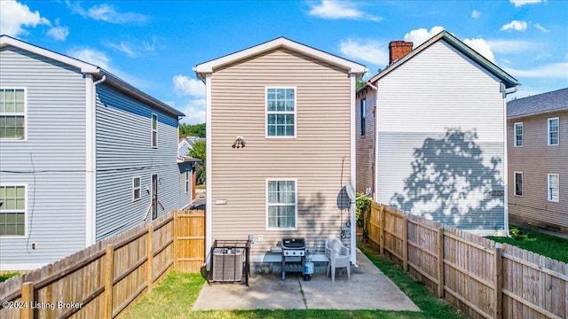 back of property featuring a patio, cooling unit, and a fenced backyard