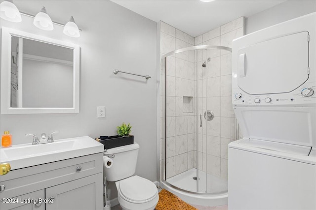 full bathroom with a stall shower, stacked washer and clothes dryer, vanity, and toilet