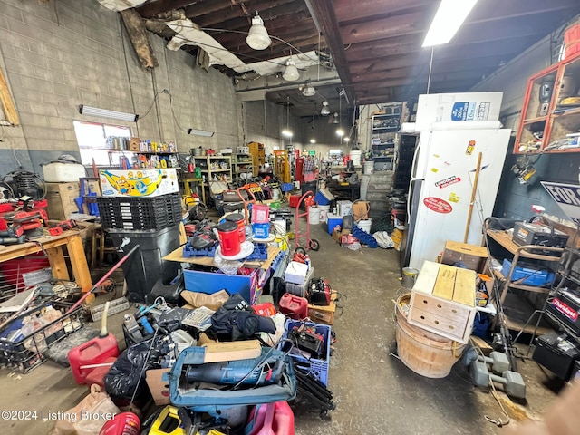 garage with white fridge and a workshop area