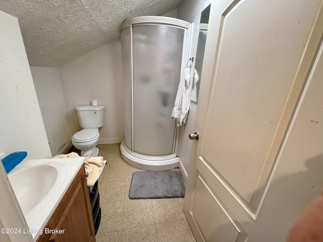 bathroom featuring tile patterned flooring, walk in shower, toilet, vanity, and a textured ceiling