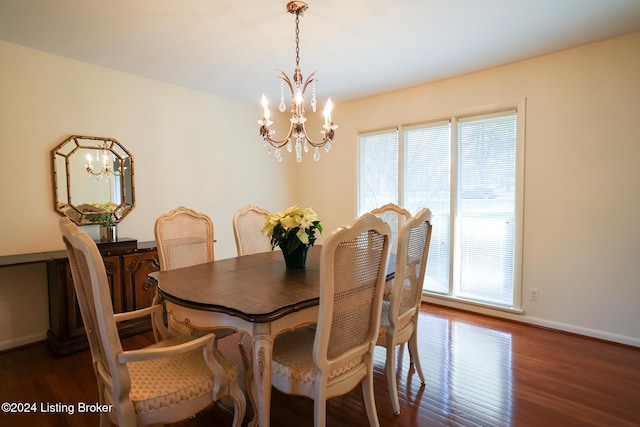 dining room with dark hardwood / wood-style floors, a wealth of natural light, and a notable chandelier