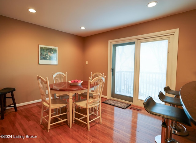 dining area with hardwood / wood-style floors