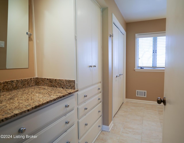 bathroom with tile patterned flooring and vanity