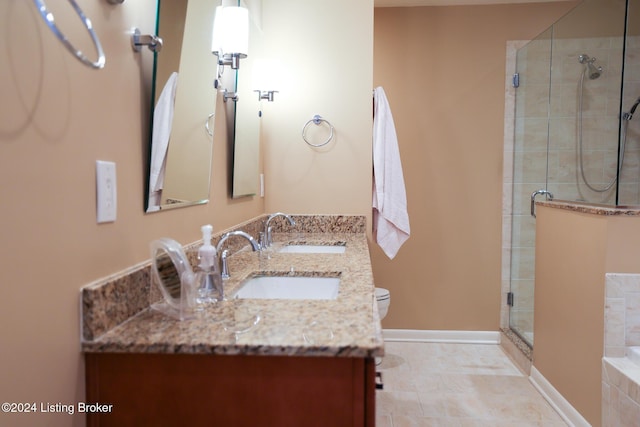 bathroom featuring toilet, an enclosed shower, and vanity