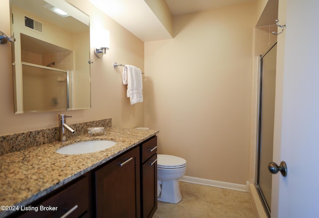 bathroom with vanity, toilet, and an enclosed shower