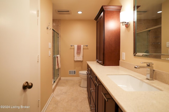 bathroom featuring vanity, toilet, and an enclosed shower