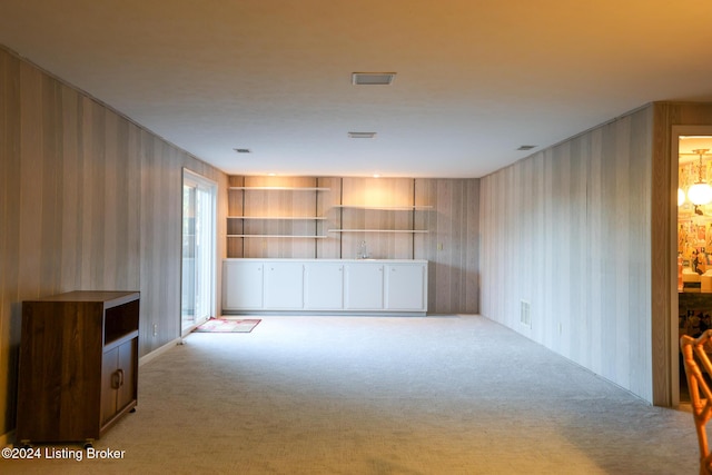 unfurnished living room featuring light carpet