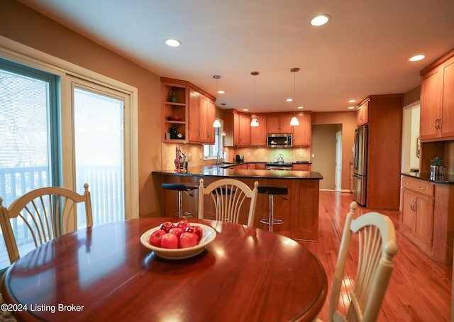 dining room with sink and light hardwood / wood-style floors