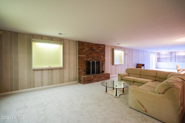 carpeted living room with a brick fireplace