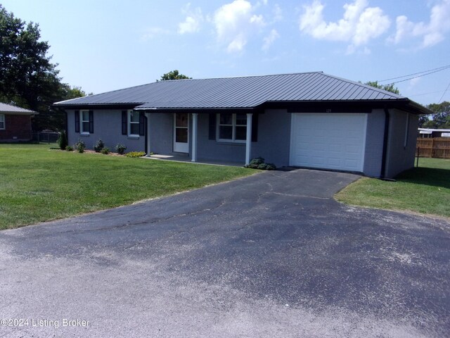 single story home featuring a garage and a front lawn