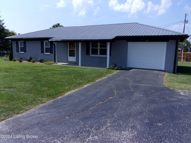 single story home with a front yard and a garage