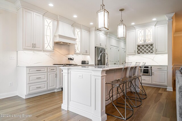 kitchen featuring hardwood / wood-style floors and white cabinets