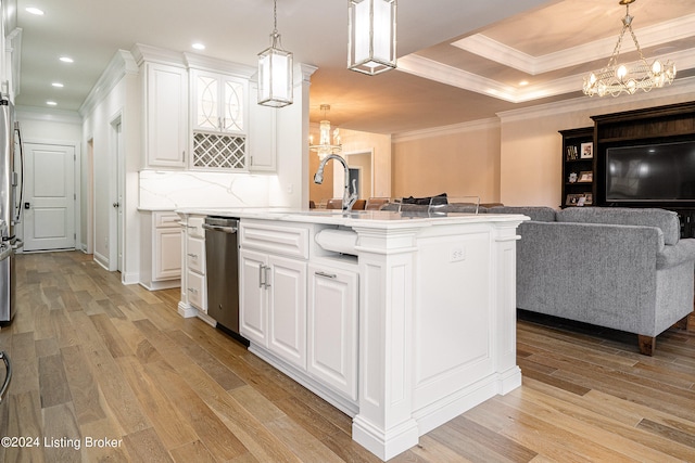 kitchen featuring a tray ceiling, pendant lighting, light hardwood / wood-style floors, and ornamental molding