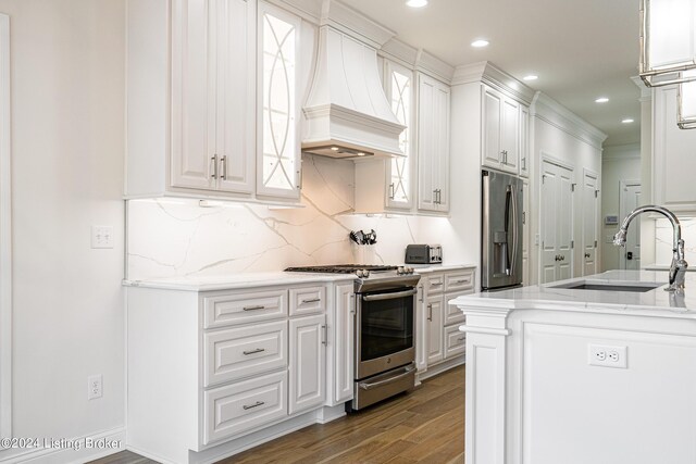 kitchen featuring custom range hood, wood-type flooring, stainless steel appliances, sink, and white cabinets