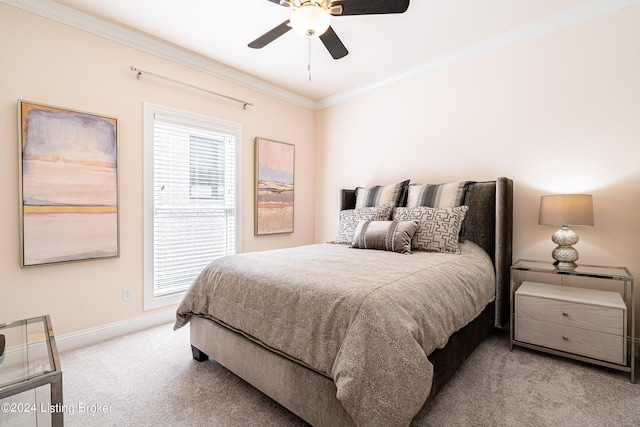 carpeted bedroom with crown molding and ceiling fan