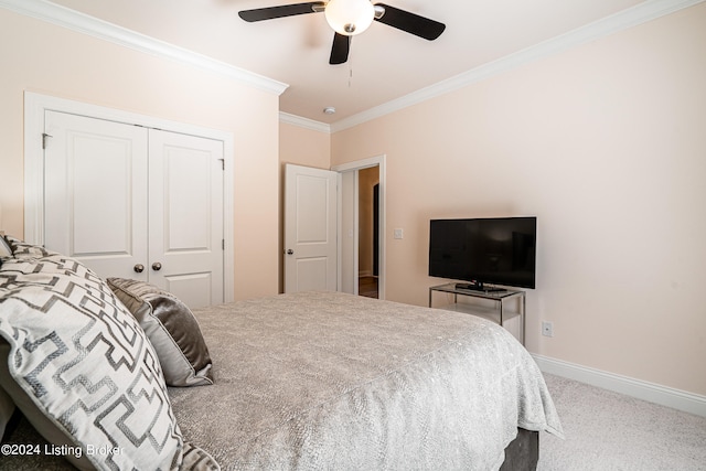 bedroom with a closet, light colored carpet, ornamental molding, and ceiling fan