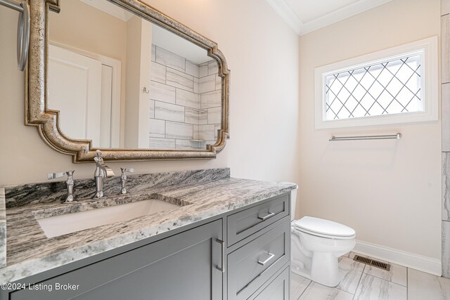 bathroom featuring crown molding, vanity, toilet, and walk in shower