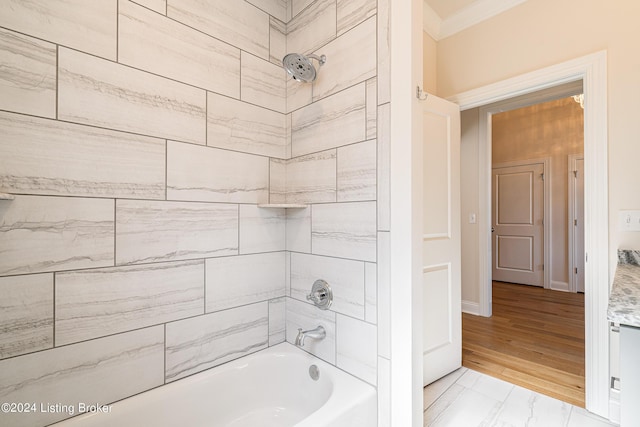 bathroom featuring baseboards, marble finish floor, tub / shower combination, and ornamental molding