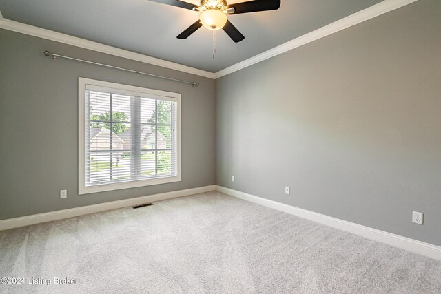 carpeted empty room featuring crown molding and ceiling fan