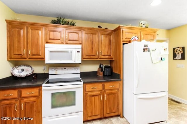 kitchen with light tile patterned floors and white appliances