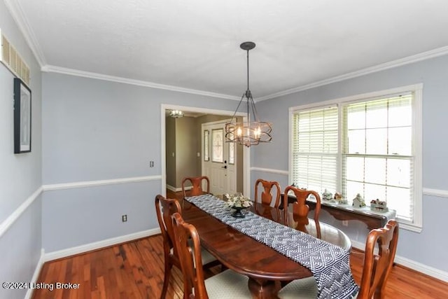 dining room featuring wood-type flooring, plenty of natural light, and ornamental molding