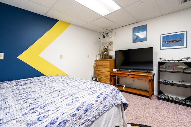 bedroom with carpet flooring and a drop ceiling