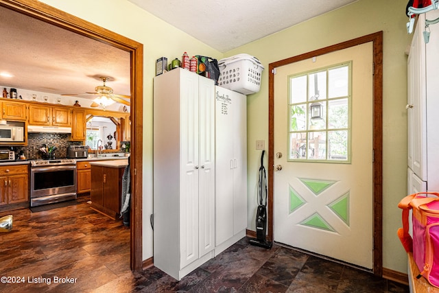 entryway featuring a textured ceiling and ceiling fan