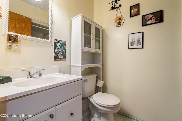 bathroom featuring vanity, toilet, and tile patterned floors