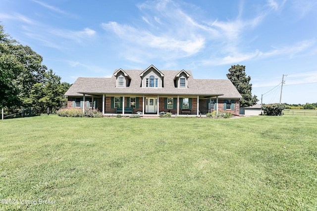 cape cod house featuring a porch and a front yard