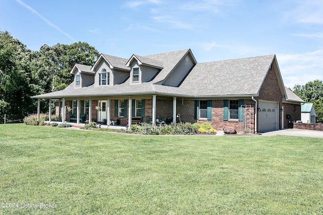 view of front of home with covered porch, a garage, and a front lawn