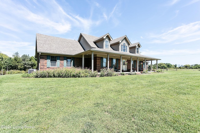 view of front facade featuring central air condition unit, a front lawn, and a porch