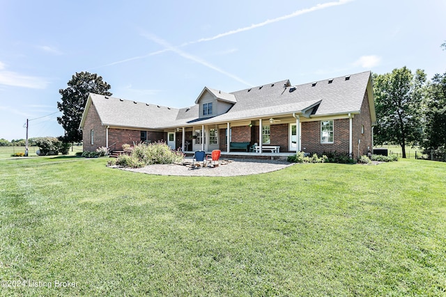 back of property featuring a patio and a yard