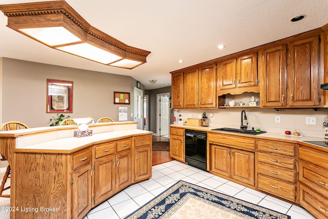 kitchen with a breakfast bar, sink, a center island, light wood-type flooring, and black appliances