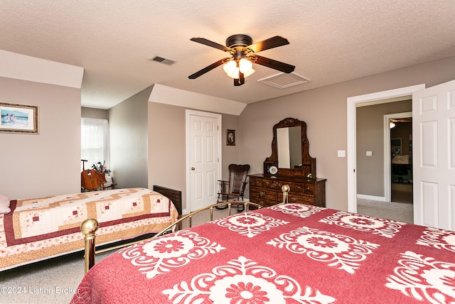 bedroom featuring ceiling fan, carpet, and a textured ceiling