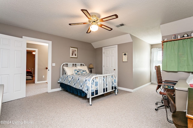 bedroom featuring ceiling fan, carpet flooring, and a textured ceiling