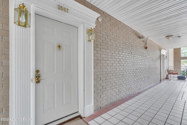 view of exterior entry with covered porch