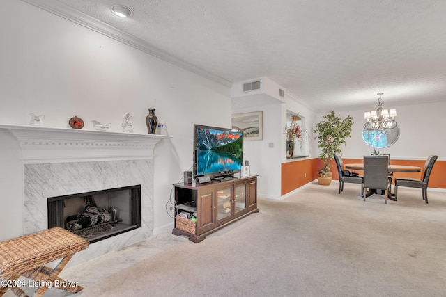 carpeted living room with ornamental molding, a premium fireplace, a chandelier, and a textured ceiling