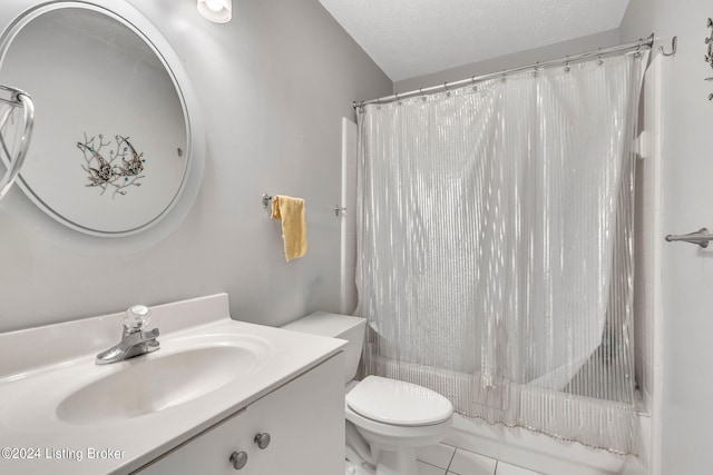 full bathroom featuring a textured ceiling, vanity, shower / tub combo with curtain, toilet, and tile patterned floors