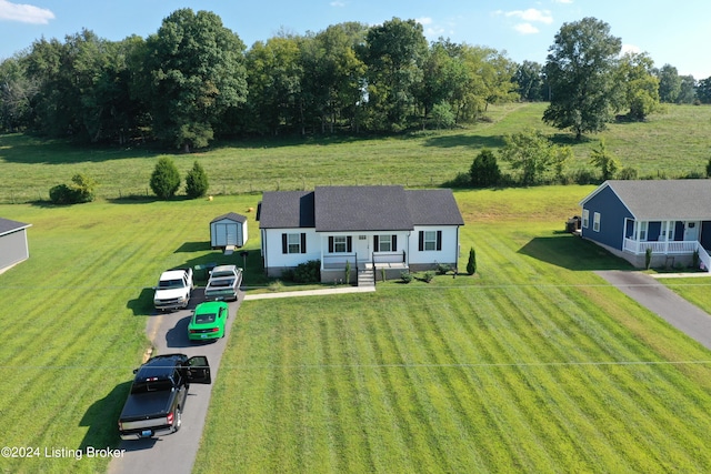 view of front of home with an outdoor structure and a front yard