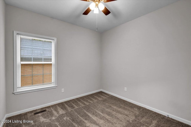 carpeted spare room featuring ceiling fan and a healthy amount of sunlight